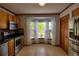 Bright kitchen featuring modern appliances, tile flooring, and natural light flooding through the window at 2334 W Doris St, Kissimmee, FL 34741