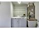 Functional laundry area with washer, dryer, utility sink, and storage shelving at 2334 W Doris St, Kissimmee, FL 34741