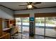 Bright office space with pool view, built-in desk, and natural light from sliding glass doors to the lanai at 2334 W Doris St, Kissimmee, FL 34741