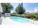 Backyard oasis with inground pool, decorative fountain, mature trees, and a sunny seating area at 2334 W Doris St, Kissimmee, FL 34741