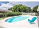 Private backyard with inground pool, surrounded by lush landscaping and a sunny seating area at 2334 W Doris St, Kissimmee, FL 34741