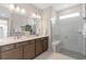 Modern bathroom with double vanity, spacious glass-enclosed shower, and contemporary tile design at 2338 Lily Bloom Rd, St Cloud, FL 34771