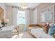 Cozy bedroom with a daybed, desk, and natural textures, creating a warm and inviting space at 2338 Lily Bloom Rd, St Cloud, FL 34771