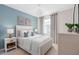 Well-lit bedroom features neutral decor, a large window, and an elegant sphere pendant lighting fixture at 2338 Lily Bloom Rd, St Cloud, FL 34771