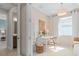 Comfortable bedroom with desk and view of en-suite bathroom; bright and featuring natural light at 2338 Lily Bloom Rd, St Cloud, FL 34771