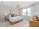 Relaxing primary bedroom featuring a serene view, textured wall, neutral decor, and a cozy woven bed frame at 2338 Lily Bloom Rd, St Cloud, FL 34771