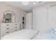 Bright bedroom with a large closet and a decorative dresser with a stylish arch mirror at 2338 Lily Bloom Rd, St Cloud, FL 34771