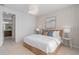 Bedroom with soft, neutral tones, a bed with a woven headboard, and access to an en-suite bathroom at 2338 Lily Bloom Rd, St Cloud, FL 34771