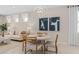 Cozy dining area adjacent to a spacious living room featuring modern lighting and neutral tones at 2338 Lily Bloom Rd, St Cloud, FL 34771