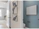 Hallway leading to half bath with stylish artwork; a bright, inviting, and functional design element at 2338 Lily Bloom Rd, St Cloud, FL 34771