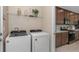 Functional laundry area complete with appliances and ample shelf storage space next to the kitchen at 2338 Lily Bloom Rd, St Cloud, FL 34771