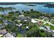 Stunning aerial view of a waterfront home with lush landscaping and boat dock on a beautiful lake at 2417 Bayfront Pkwy, Orlando, FL 32806