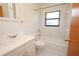 Bright bathroom with white tiled walls, neutral accents, and a combined tub and shower at 2417 Bayfront Pkwy, Orlando, FL 32806