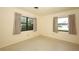 Empty bedroom featuring two large windows, neutral walls, and simple flooring at 2417 Bayfront Pkwy, Orlando, FL 32806