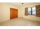 Bedroom with sliding closet doors, terrazzo flooring, and view of neighborhood at 2417 Bayfront Pkwy, Orlando, FL 32806
