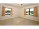 Bedroom with neutral walls, terrazzo flooring, and natural light from large windows at 2417 Bayfront Pkwy, Orlando, FL 32806