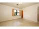 Cozy bedroom with terrazzo flooring, natural light, and a view to the neighborhood at 2417 Bayfront Pkwy, Orlando, FL 32806