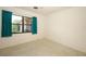 Simple bedroom with neutral walls, terrazzo floors, and natural light from a window at 2417 Bayfront Pkwy, Orlando, FL 32806