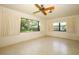 Bright bedroom offering ample light from the large windows showcasing the backyard at 2417 Bayfront Pkwy, Orlando, FL 32806