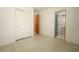 Bedroom featuring terrazzo flooring, a sliding closet, and an adjacent bathroom at 2417 Bayfront Pkwy, Orlando, FL 32806