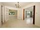 Open dining room area boasting terrazzo flooring, a chandelier, and french doors that open to another living space at 2417 Bayfront Pkwy, Orlando, FL 32806