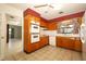 Classic kitchen with wood cabinetry, tile flooring, and double oven at 2417 Bayfront Pkwy, Orlando, FL 32806