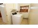 Well-lit laundry area equipped with a washing machine and dryer at 2417 Bayfront Pkwy, Orlando, FL 32806