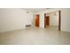 Open-concept living area featuring terrazzo flooring, neutral paint, and open doorways to other rooms at 2417 Bayfront Pkwy, Orlando, FL 32806