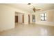 Bright living room featuring neutral walls, terrazzo flooring, and access to multiple rooms at 2417 Bayfront Pkwy, Orlando, FL 32806