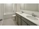 Modern bathroom with dual sinks, light countertops, and a tub shower combination with tiled walls at 2739 San Marco Way, Winter Haven, FL 33884