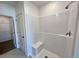Shower in bathroom with white tiled walls and a built in bench at 2739 San Marco Way, Winter Haven, FL 33884
