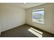 Empty bedroom with neutral carpet and one window showing other houses at 2739 San Marco Way, Winter Haven, FL 33884