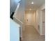 Light and neutral entryway with tile flooring, a staircase, and a front door with a smart lock at 2739 San Marco Way, Winter Haven, FL 33884