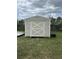 Exterior view of backyard shed offering extra storage, with crossed design on door at 2830 Gramercy Dr, Deltona, FL 32738