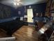 Stylish bedroom featuring hard wood floors, dark blue paint, and posters at 2830 Gramercy Dr, Deltona, FL 32738