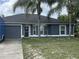 Charming single-story home with a gray exterior, front yard, and two palm trees at 2830 Gramercy Dr, Deltona, FL 32738