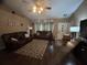 Spacious living room featuring hardwood floors, neutral walls, and two leather couches at 2830 Gramercy Dr, Deltona, FL 32738