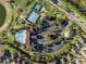 Stunning aerial view of community pool, tennis courts, clubhouse, and parking area at 3210 Sonesta Ct # B, Clermont, FL 34711
