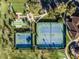 Birds-eye view of tennis and shuffleboard courts, plus a putting green, providing a fun recreational setting at 3210 Sonesta Ct # B, Clermont, FL 34711