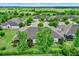 Aerial view of a home with an abundance of green landscaping and a screened patio at 3210 Sonesta Ct # B, Clermont, FL 34711