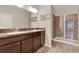 Bathroom featuring a double vanity with granite countertops and glass-enclosed shower at 3210 Sonesta Ct # B, Clermont, FL 34711