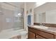 Bathroom with shower-tub combo and glass doors, dark brown vanity and tile flooring at 3210 Sonesta Ct # B, Clermont, FL 34711