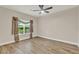 This bedroom features tile flooring, window with decorative curtains, and neutral paint at 3210 Sonesta Ct # B, Clermont, FL 34711