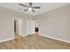 Spacious bedroom with wood-look tile flooring and a ceiling fan at 3210 Sonesta Ct # B, Clermont, FL 34711