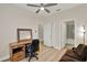 Cozy bedroom with wood-look tile flooring and modern ceiling fan, adjacent to an ensuite bathroom at 3210 Sonesta Ct # B, Clermont, FL 34711