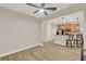 Open dining area features wood-look tile flooring and a ceiling fan, adjacent to the kitchen with bar seating at 3210 Sonesta Ct # B, Clermont, FL 34711