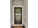 Inviting front door with welcome mat framed by white trim offers a warm entry to the property at 3210 Sonesta Ct # B, Clermont, FL 34711