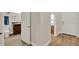 Hallway view leading to bathroom and front door featuring wood-look flooring at 3210 Sonesta Ct # B, Clermont, FL 34711