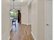 Hallway view towards screened in lanai and bar seating, featuring wood-look flooring at 3210 Sonesta Ct # B, Clermont, FL 34711