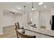 Kitchen bar has granite counters, sink, and pendant lighting; opens to the living room and dining area at 3210 Sonesta Ct # B, Clermont, FL 34711
